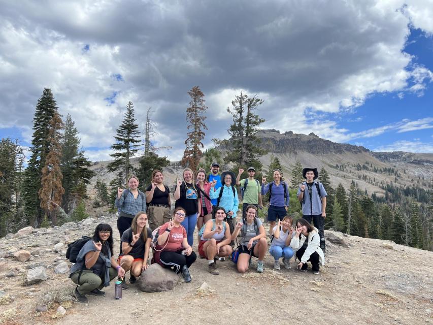 A group of sac state students posing for a group photo on a guided hiking trip in tahoe.
