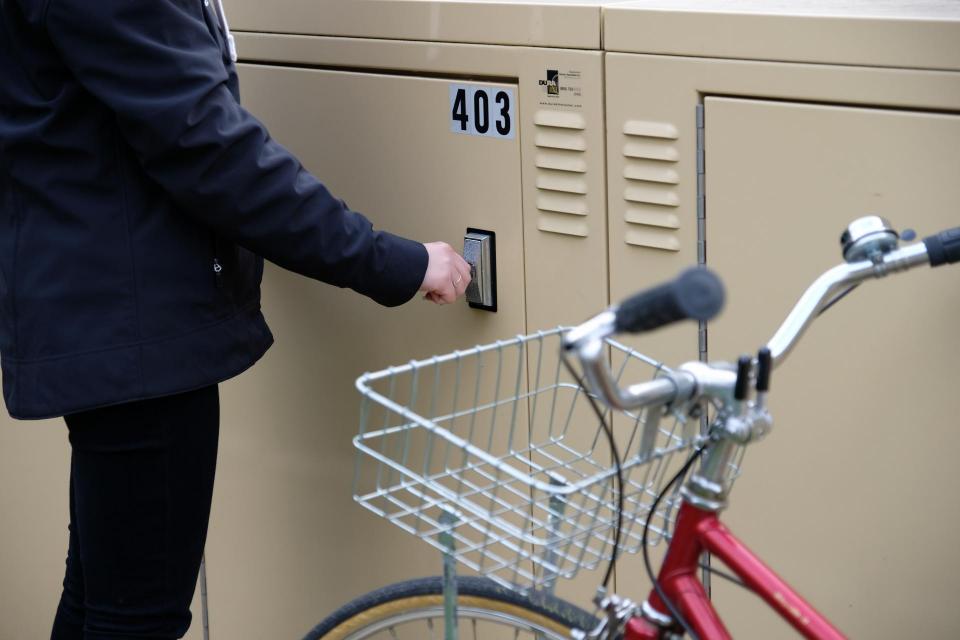 Person opening a bike locker at Sac State.