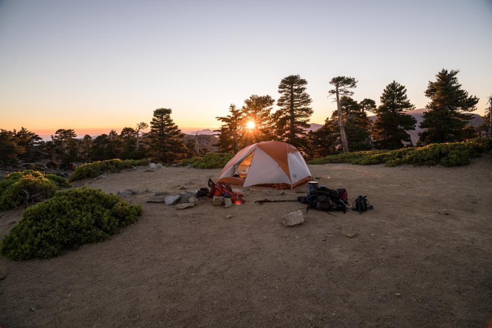 Backpacking tent and gear in the sunset.