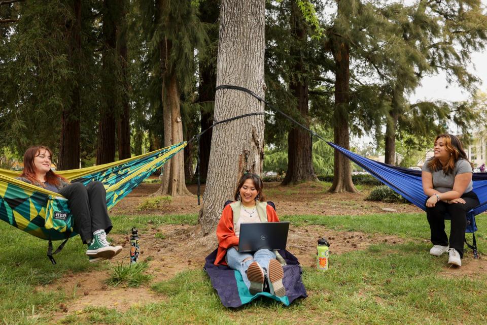 a group of college students laughing in ENO hammocks