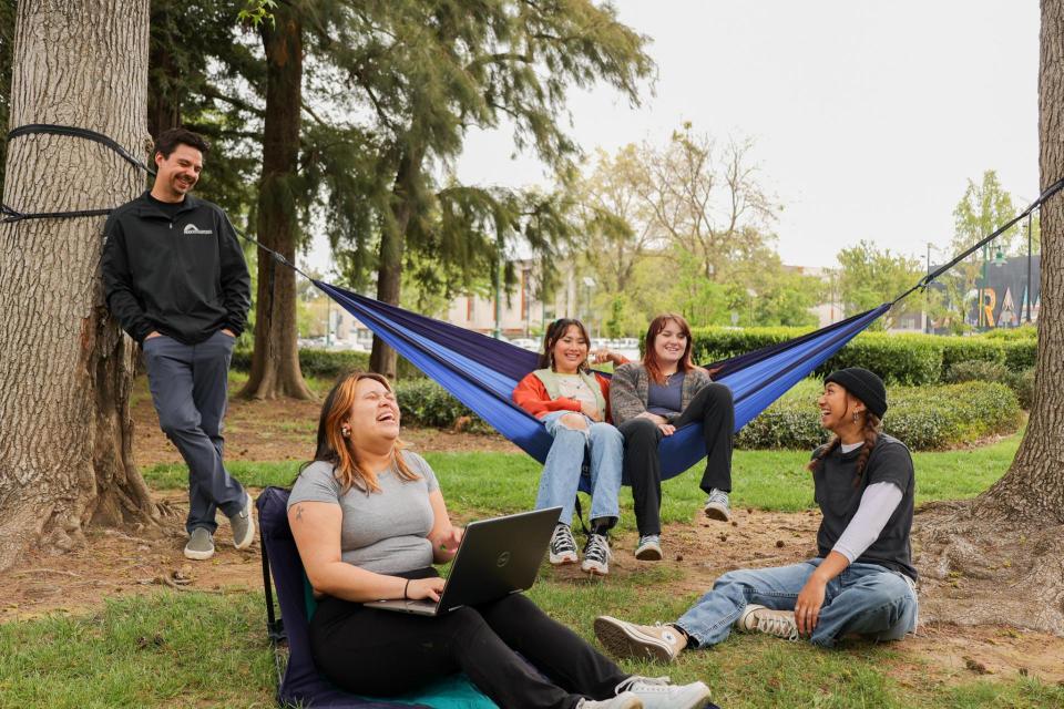 Students laughing in hammocks