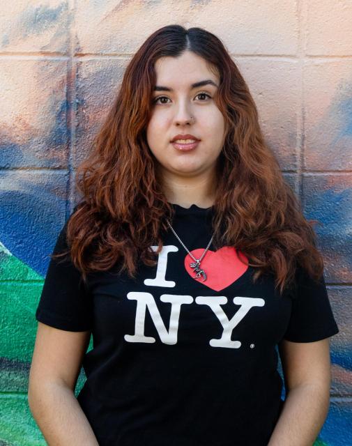 Juliana standing in front of a mural 