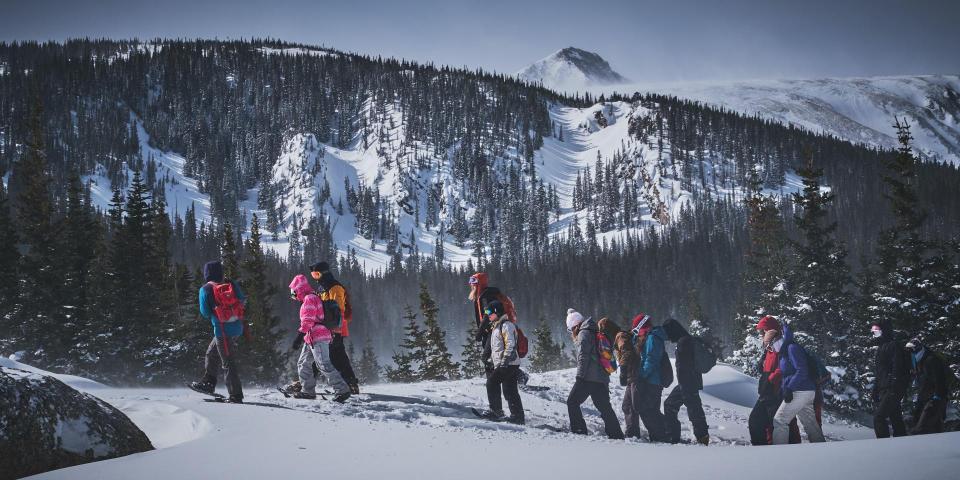 group snowshoeing on a mountain ridge