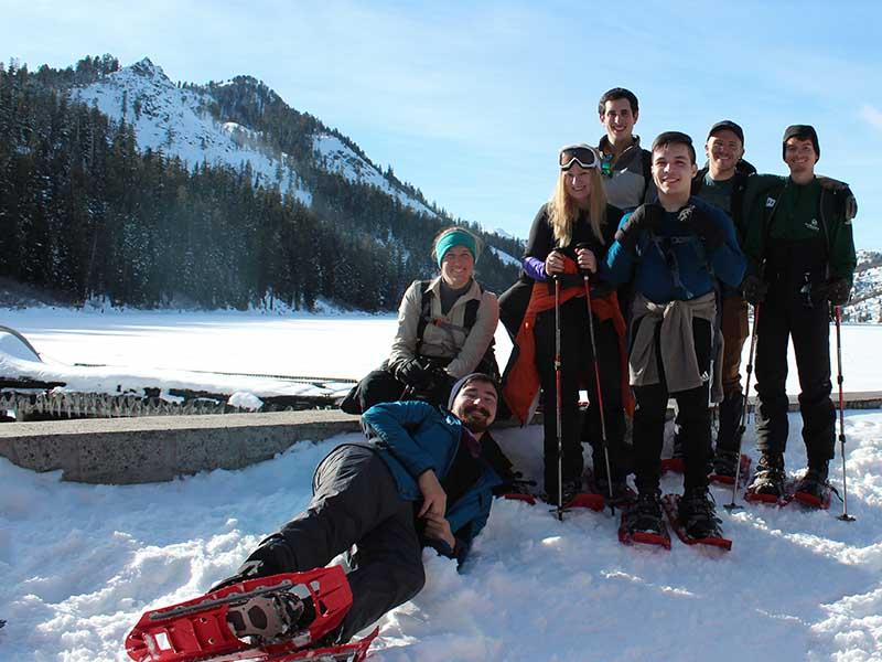 Group in snow with red snowshoes