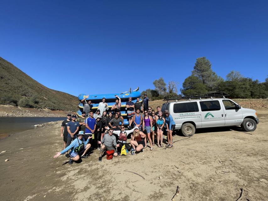 a group in front of a raft trailer with the pepak adventures van