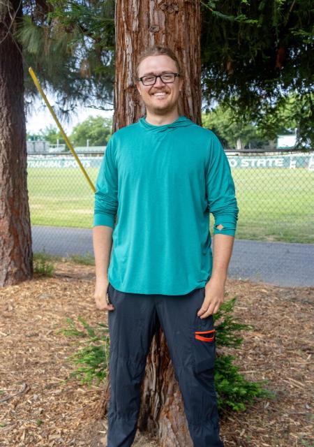 Perry-Reed in front of a tree